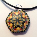 A mandala pendant with the rich golds of autumn
